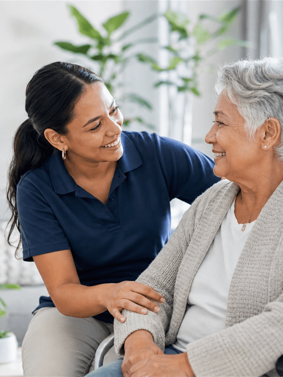 Support worker smiling with an older participant at home